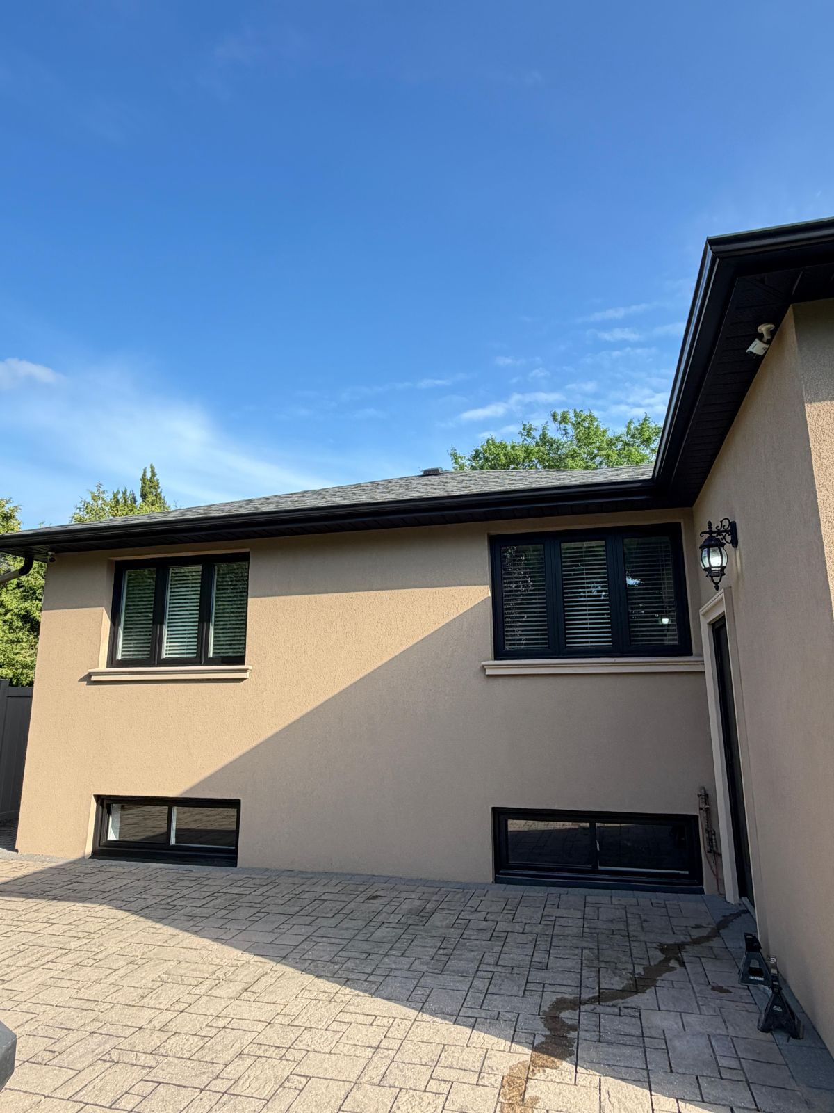 Stucco painting β tan stucco finish with black windows, GTA